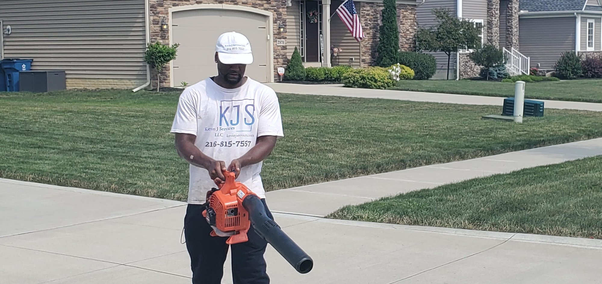 After an lawn mowing service in Willowick an employee from Kevin J Services blows off the driveway.