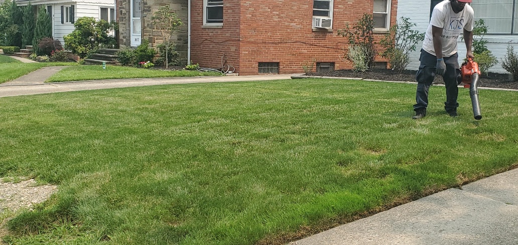 Kevin J Services employee using leaf blower after lawn mowing service in Euclid. Ohio.