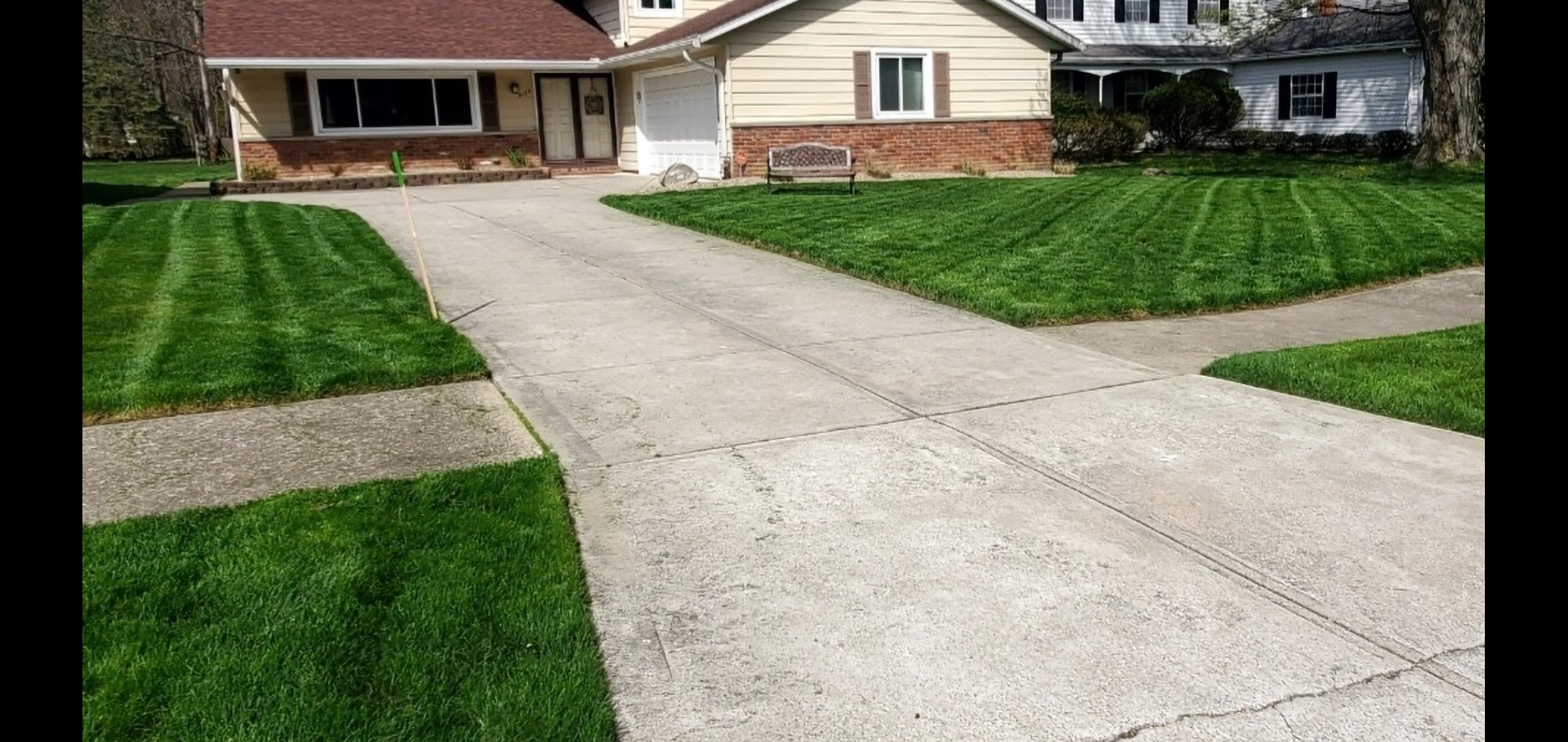 A front yard lawn in Euclid, OH, is denser and greener after an aeration and overseeding service from Kevin J Services