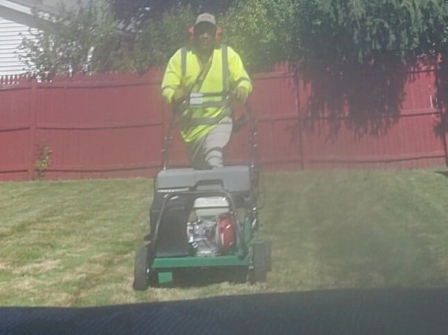 The owner of Kevin J Services preforms an aeration and overseeding service at a backyard in Euclid, Ohio. The owner of Kevin J Services preforms an aeration and overseeding service at a backyard in Euclid, Ohio.